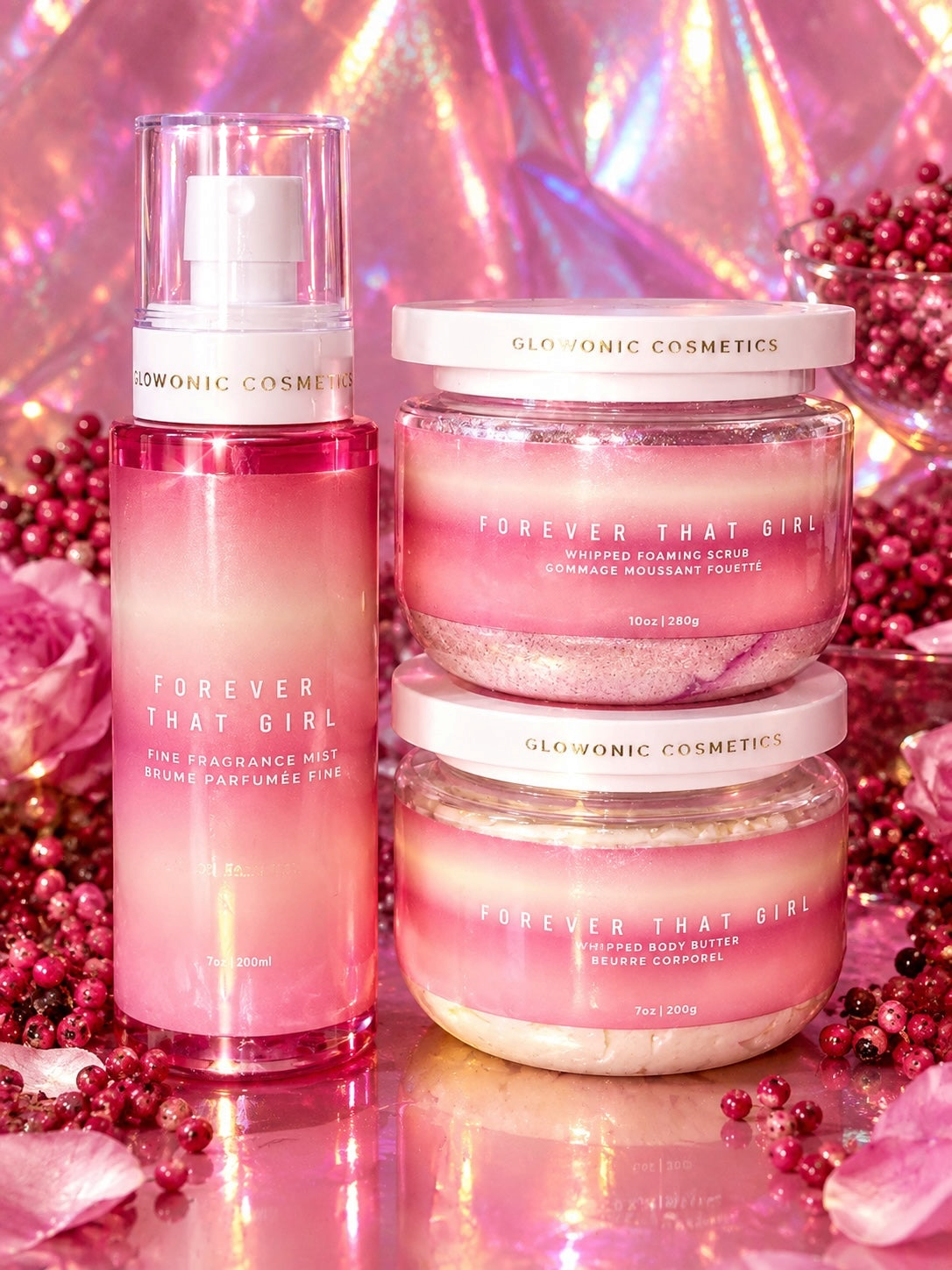 Glowonic Cosmetics Forever That Girl fragrance mist, foaming scrub, and body butter set with pink floral accents.